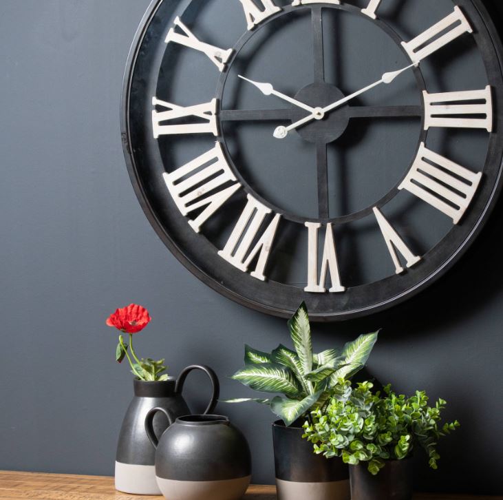 Black Framed Skeleton Clock With White Roman Numerals